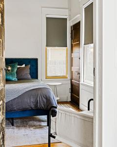 a bedroom with a blue bed and a window at Boutique Home in Historic King William in San Antonio