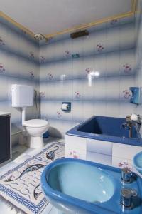 a bathroom with a blue sink and a toilet at Nikos apartment - Lakka Paxos in Lákka