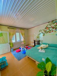 a bedroom with a green bed with a white ceiling at Rose's House in Da Lat