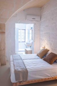 a bedroom with a large bed in a white room at Pere Alcantara 40, 3 bedroom house, Ciutadella in Ciutadella