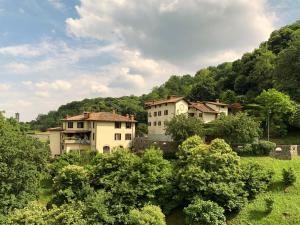 a group of houses in a field with trees at La Valletta Relais in Bergamo