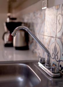 a kitchen sink with a faucet on a counter at Casa Fundadores in Valladolid +31 photos