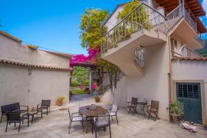 a patio with a table and chairs next to a building at Rousis Studios in Parga