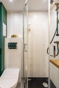 a bathroom with a toilet and a glass shower at Golden Apartments Warsaw - Stylish Luxury, Złota Street in Warsaw