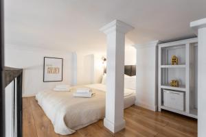 a bedroom with a bed with two towels on it at Golden Apartments Warsaw - Stylish Luxury, Złota Street in Warsaw