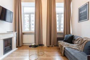 a living room with a couch and a table at Golden Apartments Warsaw - Stylish Luxury, Złota Street in Warsaw