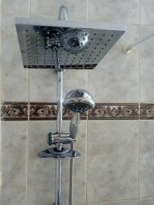a shower in a bathroom with a shower head at Trudy's home in Nicosia