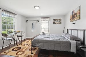 a bedroom with a bed and a table and chairs at ATL Home Close to Airport, Tyler Perry, Betline home in Atlanta