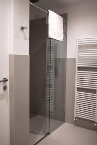 a shower stall with a glass door in a bathroom at DaNina in Verona