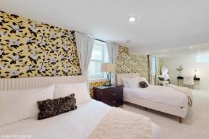 a bedroom with two beds and a floral wall at Magnolia Place in New Buffalo