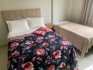 a bedroom with a bed with a blanket on it at Hotel APART Zuccolotto 303 in Aracruz
