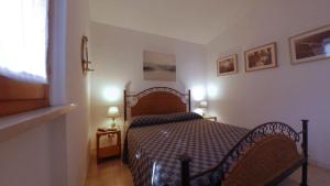 a small bedroom with a bed in a room at Conero Guest House in Numana