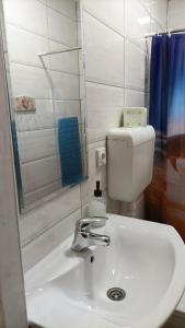 a bathroom with a white sink and a shower at sobe MAŠA in Subotica