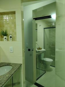 a bathroom with a toilet and a glass shower at A 5 km do aeroporto no centro do Nucleo Bandeirante in Brasilia