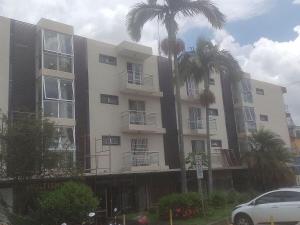 a large building with palm trees in front of it at A 5 km do aeroporto no centro do Nucleo Bandeirante 156 in Brasilia