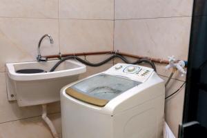 a small bathroom with a toilet and a sink at A 5 km do aeroporto no centro do Nucleo Bandeirante 156 in Brasilia