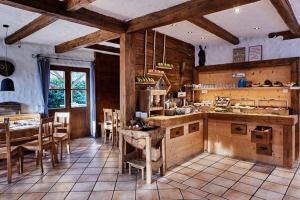 a large kitchen with a table and chairs in a room at Hotel Garni Eder in Gmund am Tegernsee