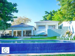 a house with a swimming pool in front of it at Villa Anastasia in Siavonga