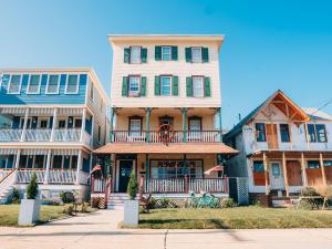 a large house with a balcony on a street at Beachliner Hotel in Ocean Grove