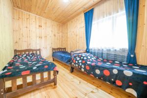 a bedroom with two beds and a window at Babi & Tata's House in Ushguli