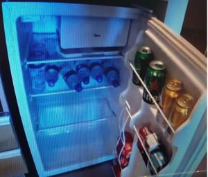 an open refrigerator filled with bottles and drinks at HOTEL Resort 2025 in Olímpia