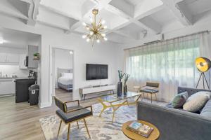 a living room with a couch and a tv at House at Phipps in Atlanta