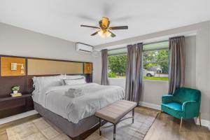 a bedroom with a bed and a blue chair at House at Phipps in Atlanta