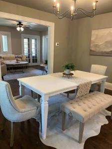 a dining room with a white table and chairs at Spanish Charm 4bed/3bath in Waupaca