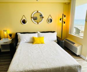a bedroom with a bed with a yellow pillow on it at Oceanfront Oasis in Daytona Beach
