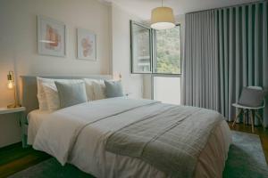 a bedroom with a large bed and a window at Kora Home in Santa Cruz