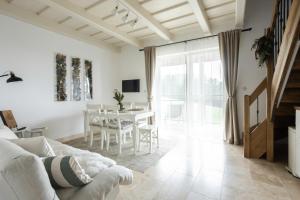 a living room with a white couch and a table at Apartmány v Beskydech in Frenštát pod Radhoštěm