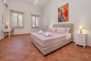 a bedroom with a bed and a table in a room at Nikolas Old Town in Rhodes Town