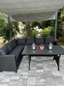 a blue couch and a table under a tent at Apartments Erenda in Fuškulin