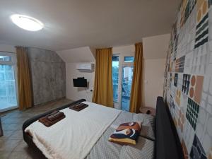 a bedroom with a bed with towels on it at Apartments Provence in Sozopol