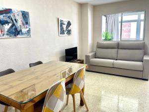 a living room with a wooden table and a couch at Apartamento Coblanca 6 in Benidorm