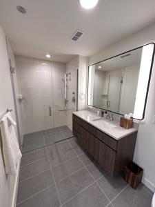 a bathroom with a sink and a shower and a mirror at Flexhome River West Studio N5 with Gym and Rooftop - READ INFO in Chicago