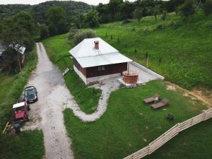 an aerial view of a small house on a hill at Cabana Valea lui Maș in Robaia