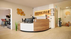 a store with a counter with a sign on the wall at Arancini Residence in Vodice