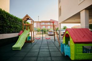 a playground with a slide and a swing at Arancini Residence in Vodice