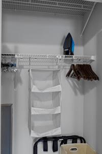 a closet with a white shelf and a rack withippers at Flexhome Economy 1BR Apt MP10 - READ INFO in Milwaukee