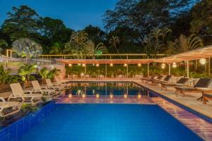 a swimming pool with lounge chairs and a resort at Hotel Villa Camila in La Pintada