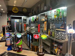 a bar with a lot of drinks on the counter at The Angel Inn in Troed-y-rhiw