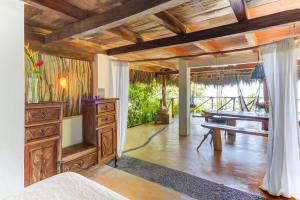 a living room with a tv and a table at Casitas Maraika in Puerto Vallarta