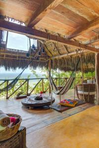a room with a hammock and a view of the ocean at Casitas Maraika in Puerto Vallarta