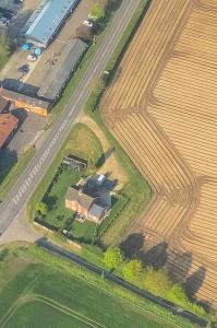 an aerial view of a farm in a field at Victorian quirky farm cottage next to forest & close to beach in Woodbridge