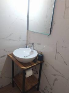 a bathroom with a white sink and a mirror at Sergi Home in Raches