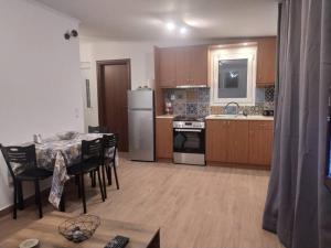 a kitchen with a table and chairs and a refrigerator at Sergi Home in Raches