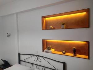 a bedroom with a bed and a shelf with clocks on it at Sergi Home in Raches