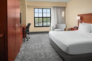 a hotel room with a bed and a desk at Courtyard Aberdeen at Ripken Stadium in Aberdeen