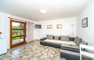 a living room with a bed and a couch at Lovely Home In Duga Resa With Outdoor Swimming Pool in Duga Resa